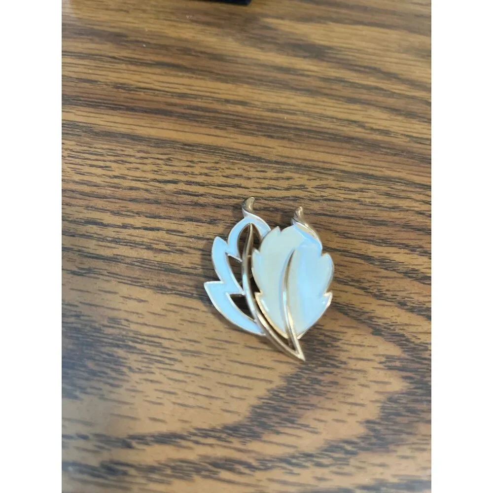 Crown Trifari gold tone and white enamel leaf design brooch